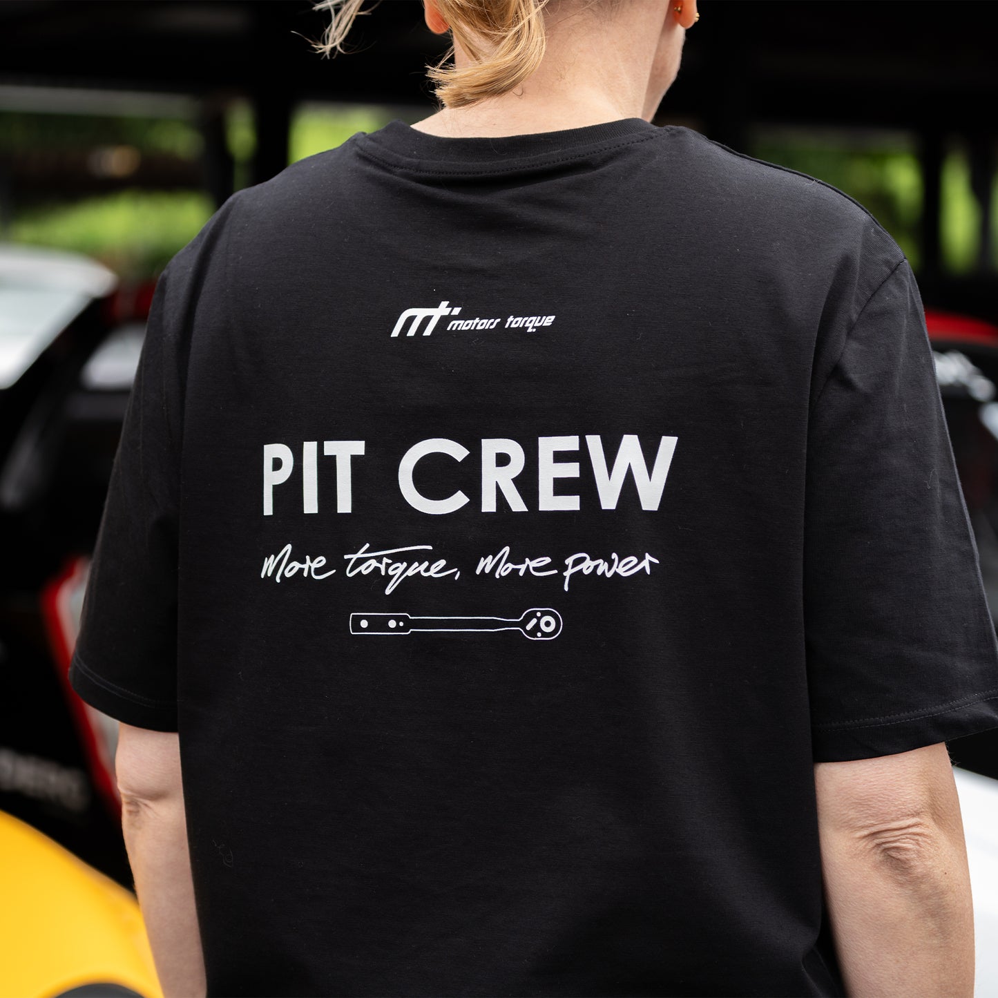 This ‘T’ is the torque wrench of our collection. Featuring our MT brand on the front. A torque wrench featured on the back as acknowledgment to pit crews and all the work they do. Validating our philosophy of ‘more torque, more power’.
Why black? Pit crew members know no other colour will do when working with engines and oil, it makes sense. This ‘T’ is inspired by a genuine member of a pit crew. It makes a statement and is a conversation starter for those who are, or who would love to be involved.