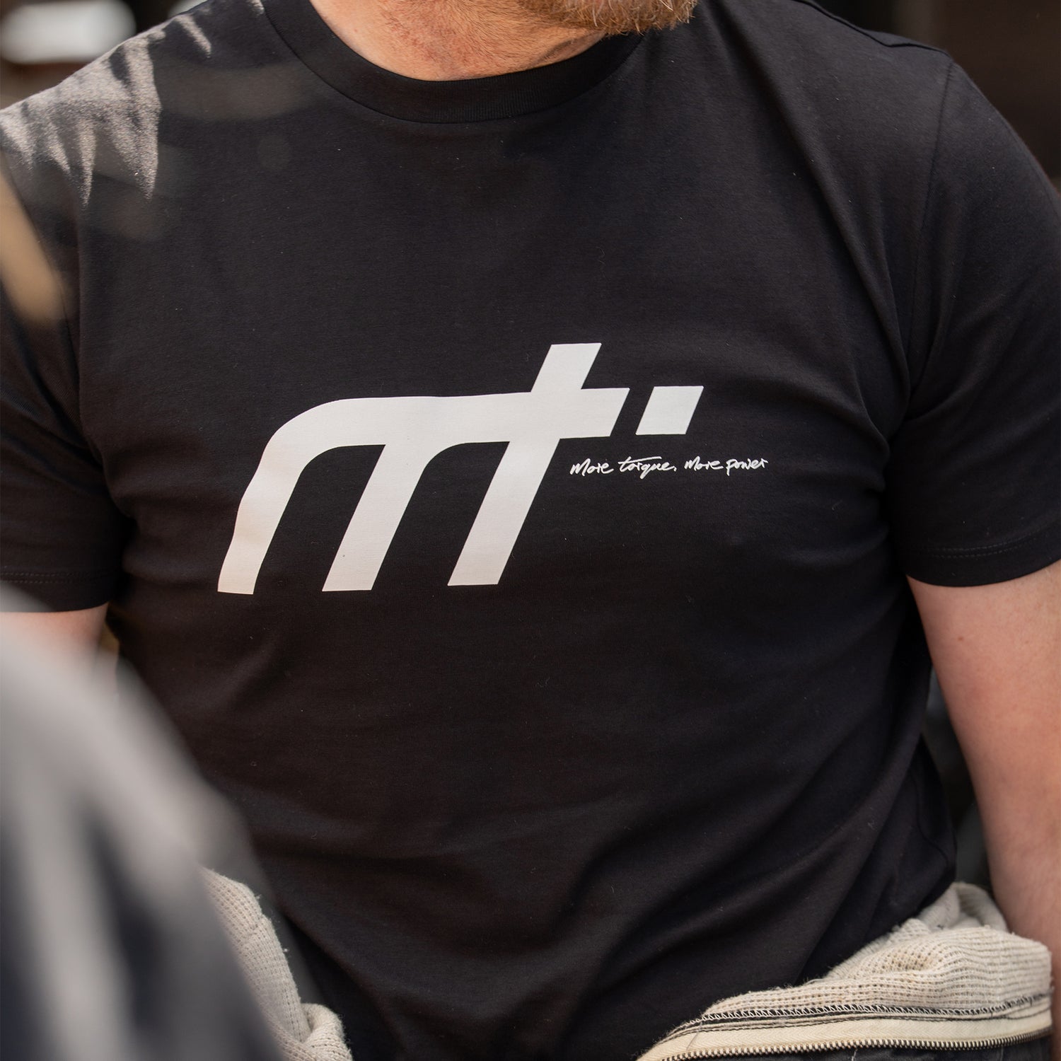 This ‘T’ forms the engine of our collection and is designed to become a longstanding classic. Featuring our MT brand on the front with our philosophy ‘more torque, more power’ vertically rising on the back.

Why black? Well anyone who is around cars knows that motor oil gets everywhere, it makes sense. The ‘T’ that started us makes a statement and conversation starter for anyone in the motor community.

Our t-shirts are soft and durable just like our community.

100% organic combed cotton.