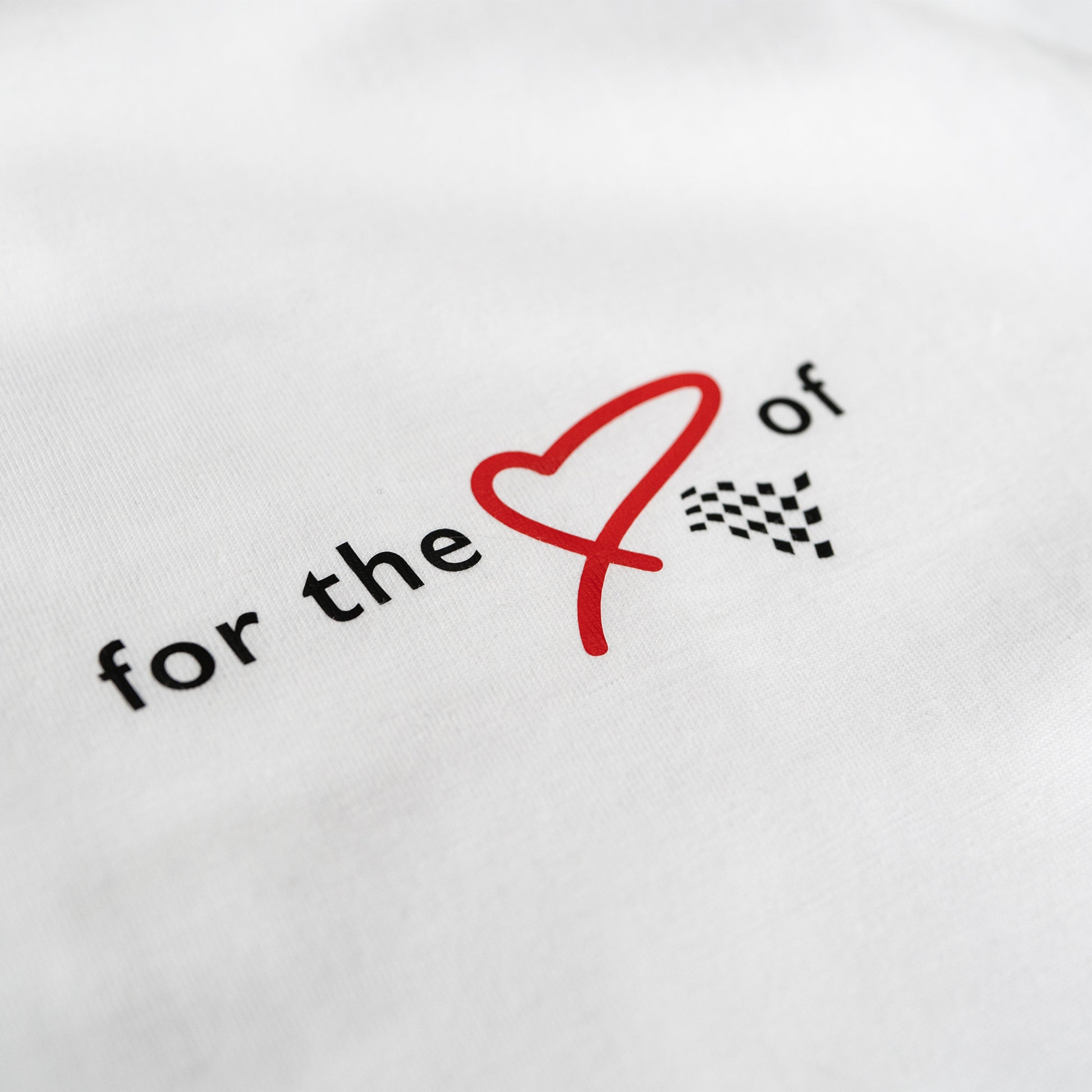 This ‘T’ is the cam of our collection. Featuring our MT brand on the front with for the love of heart and flag, with a larger heart and flag motif on the back. This ‘T’ was designed to convey the love of motorsport.

Why white? It’s a stylish backdrop for the red heart and chequered flag and cooler in the sun. This ‘T’ is inspired by a love of motorsport and is a great tribute to the thrill of the race.

Our t-shirts are soft and durable just like our community.

This ‘T’ is a ladies more snug fit (this run