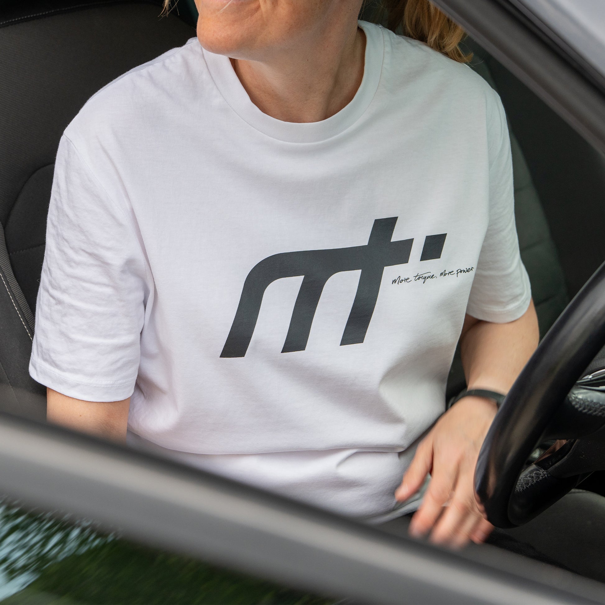 This ‘T’ forms the engine of our collection and is designed to become a longstanding classic. Featuring our MT brand on the front with our philosophy ‘more torque, more power’ vertically rising on the back. Why white? There may be a time you can avoid the oil, great for a cooler summer alternative. The ‘T’ that started us makes a statement and conversation starter for anyone in the motor community.

Our t-shirts are soft and durable just like our community.

100% organic combed cotton.