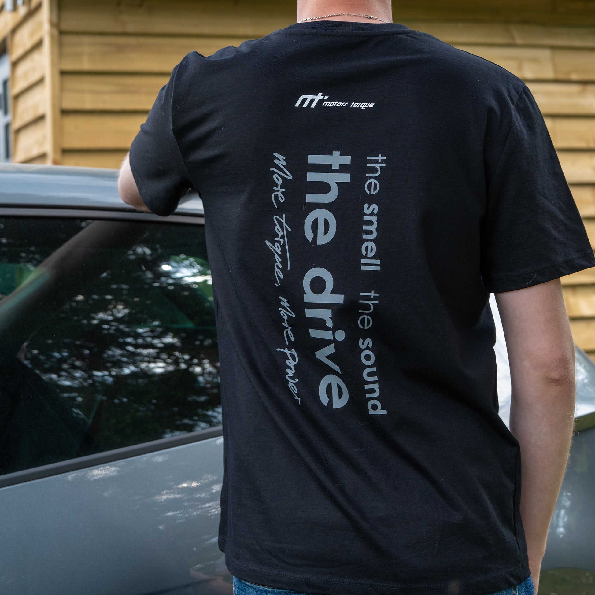 This ‘T’ is the highway of our collection. Featuring our MT brand on the front with 'the smell, the sound, the drive' on the back, a homage to all those that love motors.

Why choose black? Hides oil stains well. The ‘T’ inspired from a genuine love of motors forms the essence of a great conversation starter.

Our t-shirts are soft and durable just like our community.

100% organic combed cotton.